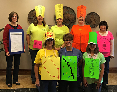 Bank of Washington employees dressed up as office supplies (highlighters and post-its) for Halloween 2018